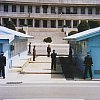 At the DMZ in South Korea looking north. Note how the guards on the right and left only reveal half of their body as they stand at the corner of the building. Must be hard looking at a wall with one eye.