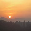 Dawn over the mountains and high-rise apartments of Seoul.