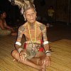 The headman in traditional garb at a longhouse in Borneo Malaysia. His right hand holds a snifter of powerful and sweet rice wine and on his left (barely visible here) is an expensive watch. When two worlds collide? Or co-exist?